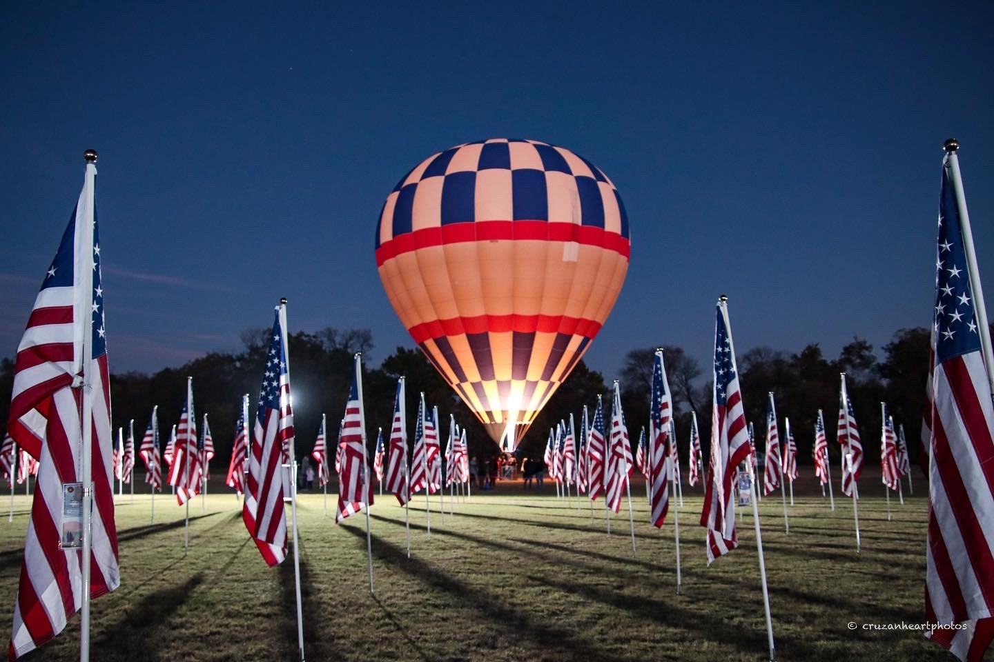 American flags surrounding a hot-air balloon at the tribute field